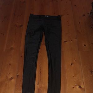 Black shiny material leggings.